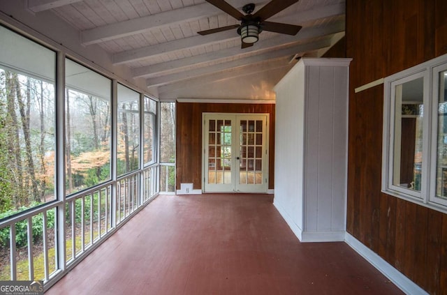 unfurnished sunroom with beam ceiling and french doors