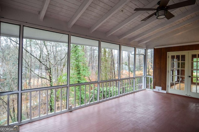 unfurnished sunroom featuring a ceiling fan, french doors, wooden ceiling, and vaulted ceiling with beams