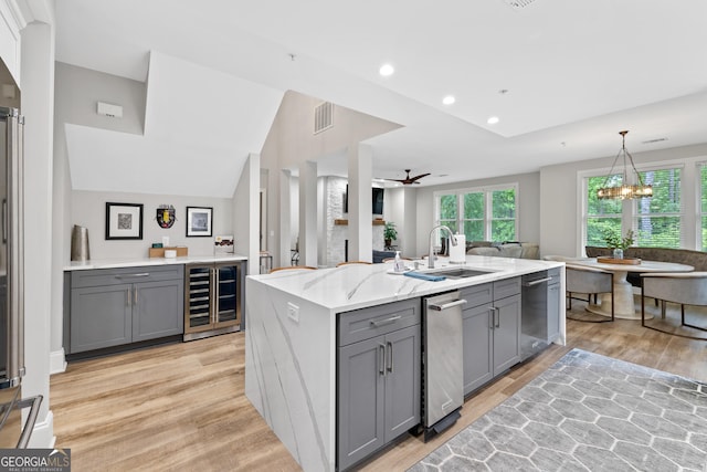 1010F Tailwater, Greensboro, GA 30642 - kitchen with visible vents, beverage cooler, light wood-style floors, gray cabinets, and a sink