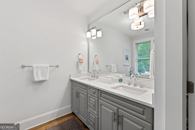 1010F Tailwater, Greensboro, GA 30642 - bathroom with double vanity, a sink, wood finished floors, and visible vents