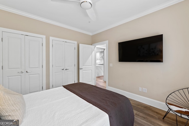 1010F Tailwater, Greensboro, GA 30642 - bedroom with ceiling fan, two closets, baseboards, wood finished floors, and ornamental molding