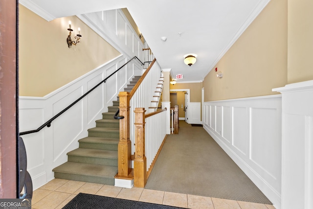 1010F Tailwater, Greensboro, GA 30642 - staircase featuring crown molding, tile patterned flooring, wainscoting, and a decorative wall