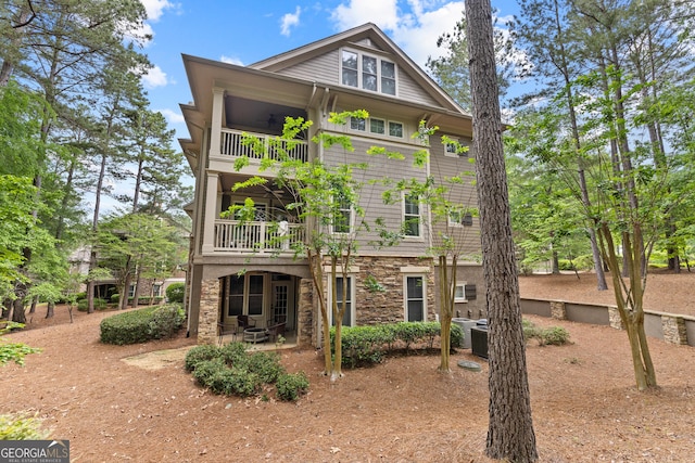 1010F Tailwater, Greensboro, GA 30642 - rear view of house with a patio, a balcony, and stone siding