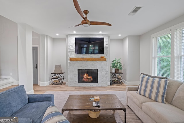 1010F Tailwater, Greensboro, GA 30642 - living area featuring visible vents, wood finished floors, a fireplace, baseboards, and a ceiling fan