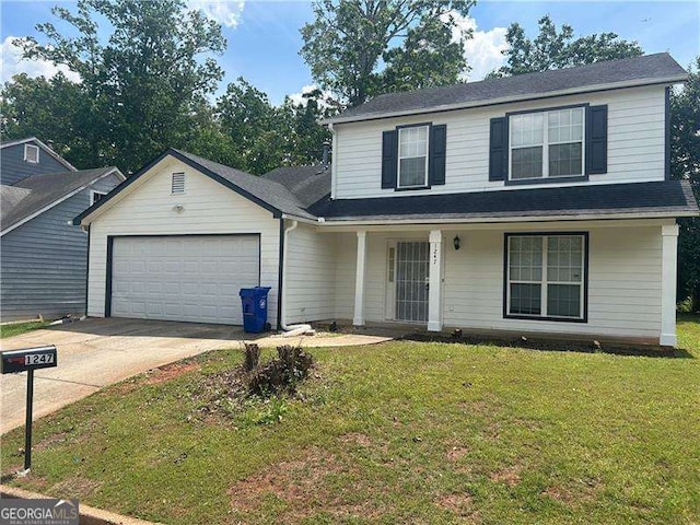 traditional home with covered porch, concrete driveway, an attached garage, and a front lawn