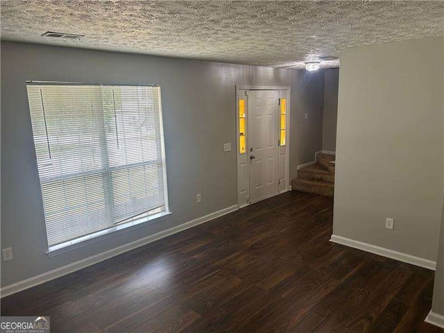entryway featuring baseboards, stairway, plenty of natural light, and wood finished floors