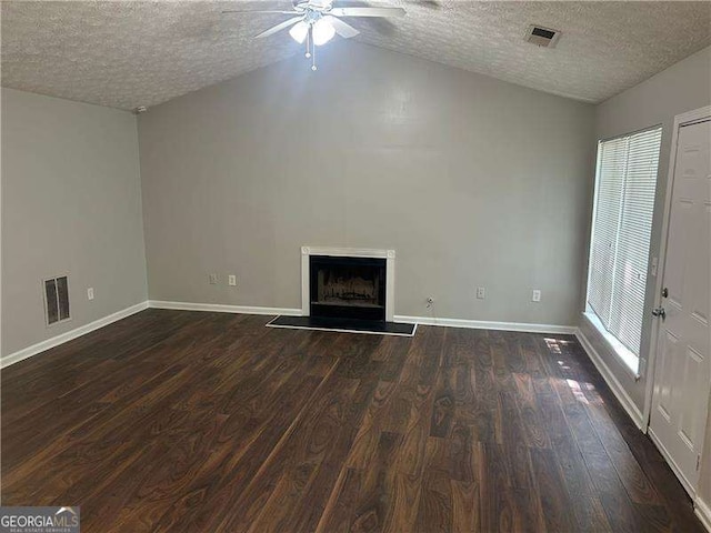 unfurnished living room featuring a textured ceiling, visible vents, ceiling fan, lofted ceiling, and dark wood-style floors