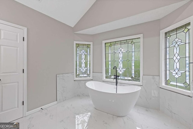 470 Brackin Trce, Grayson, GA 30017 - bathroom featuring a freestanding tub, a wainscoted wall, marble finish floor, and a wealth of natural light