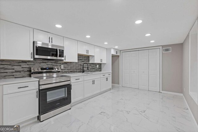 470 Brackin Trce, Grayson, GA 30017 - kitchen with appliances with stainless steel finishes, a sink, marble finish floor, baseboards, and visible vents