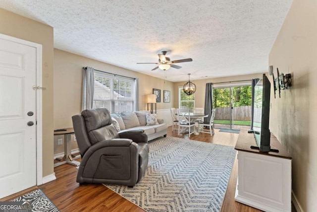 171 Nacoochee Way, Canton, GA 30114 - living area featuring wood finished floors, a ceiling fan, healthy amount of natural light, and a textured ceiling