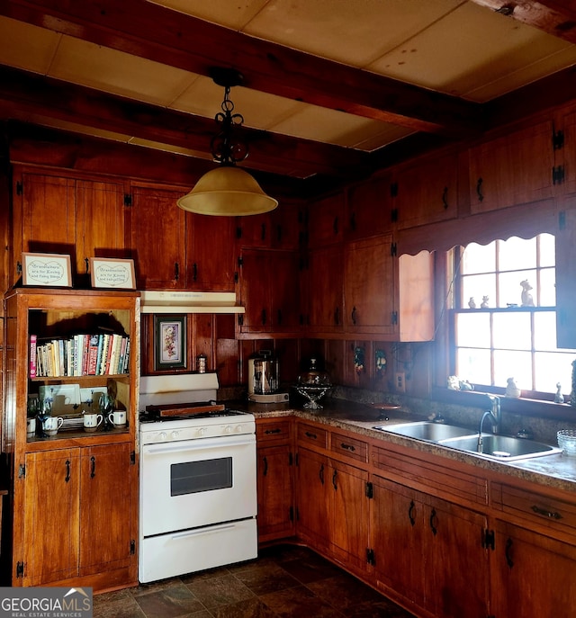 kitchen featuring brown cabinetry, a sink, under cabinet range hood, and white gas range