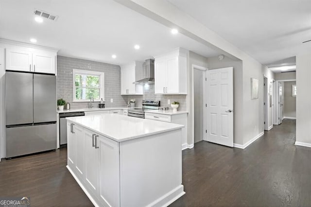 1140 Starline Dr SE, Smyrna, GA 30080 - kitchen featuring white cabinets, dark wood-style flooring, appliances with stainless steel finishes, wall chimney exhaust hood, and visible vents