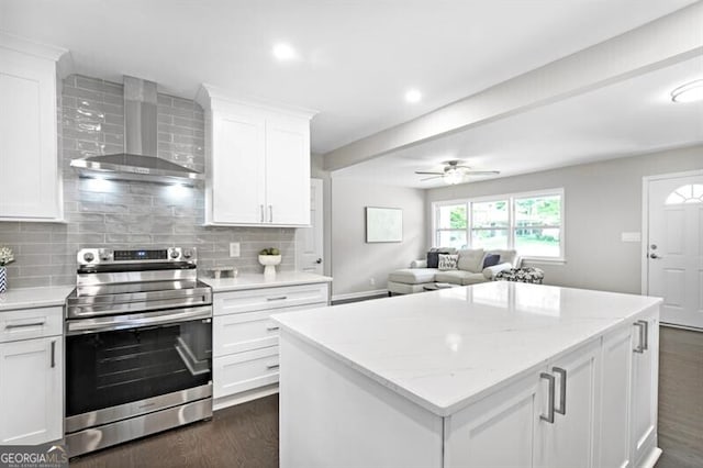 1140 Starline Dr SE, Smyrna, GA 30080 - kitchen with wall chimney range hood, white cabinetry, decorative backsplash, a kitchen island, and stainless steel electric stove