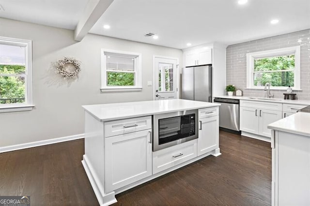 1140 Starline Dr SE, Smyrna, GA 30080 - kitchen featuring light countertops, stainless steel appliances, dark wood-style floors, and a sink