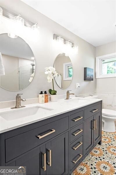 1140 Starline Dr SE, Smyrna, GA 30080 - bathroom with a sink, tile patterned floors, and double vanity