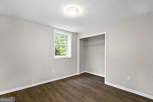1140 Starline Dr SE, Smyrna, GA 30080 - unfurnished bedroom featuring baseboards, dark wood finished floors, and a closet