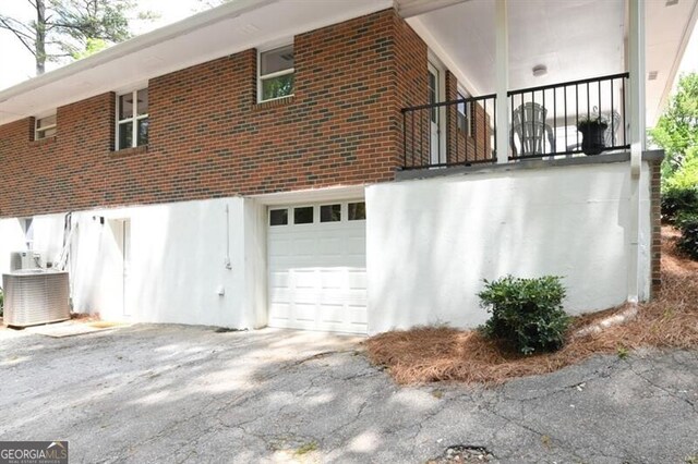 1140 Starline Dr SE, Smyrna, GA 30080 - view of side of property featuring a garage, central air condition unit, and brick siding
