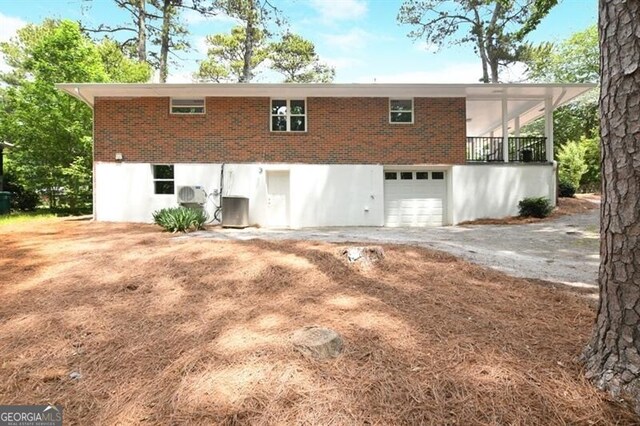1140 Starline Dr SE, Smyrna, GA 30080 - rear view of property with a garage, central air condition unit, and driveway