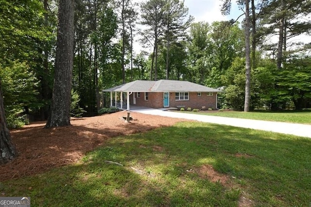 1140 Starline Dr SE, Smyrna, GA 30080 - ranch-style house featuring concrete driveway, a front yard, and a carport