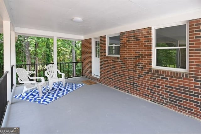 1140 Starline Dr SE, Smyrna, GA 30080 - sunroom with brick wall and concrete floors
