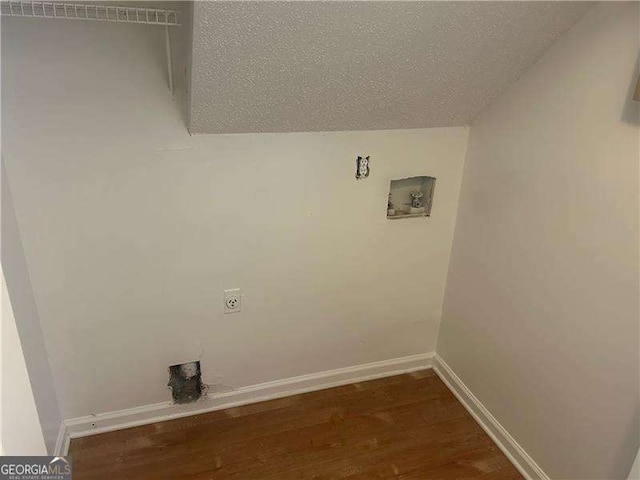 5340 Forest Pl, Stone Mountain, GA 30088 - laundry area featuring wood finished floors, washer hookup, hookup for an electric dryer, and a textured ceiling