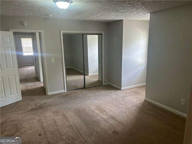 5340 Forest Pl, Stone Mountain, GA 30088 - unfurnished bedroom featuring carpet, a textured ceiling, and a closet
