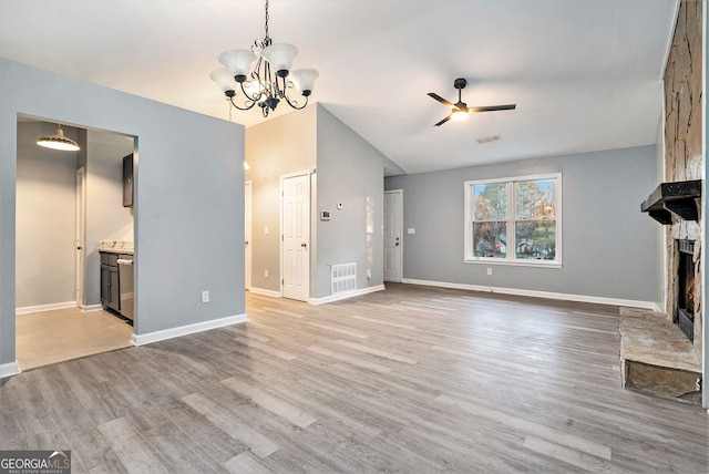 unfurnished living room with visible vents, light wood-style flooring, ceiling fan with notable chandelier, and a fireplace