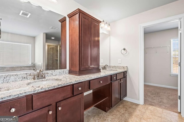 12348 Hillcrest Dr, Hampton, GA 30228 - full bathroom with a sink, a stall shower, double vanity, and visible vents