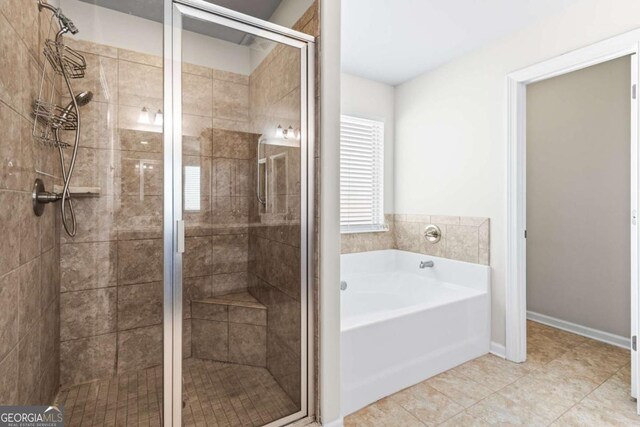 12348 Hillcrest Dr, Hampton, GA 30228 - bathroom featuring a garden tub, tile patterned floors, baseboards, and a stall shower