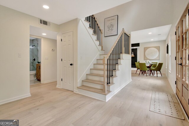 staircase with baseboards, recessed lighting, wood finished floors, and visible vents
