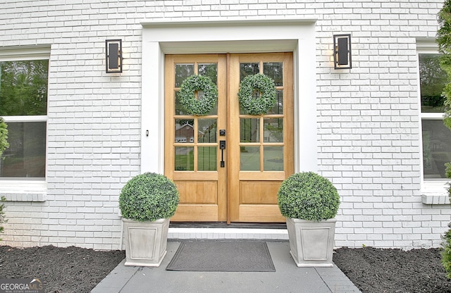 entrance to property with brick siding and french doors
