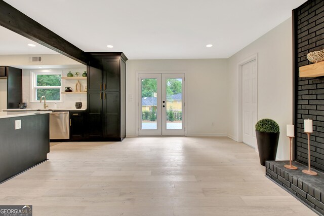 unfurnished living room with visible vents, recessed lighting, light wood-style flooring, and french doors