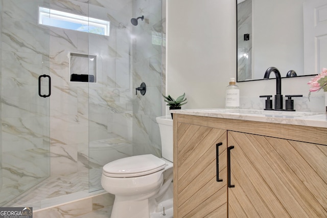 bathroom with toilet, a marble finish shower, marble finish floor, and vanity