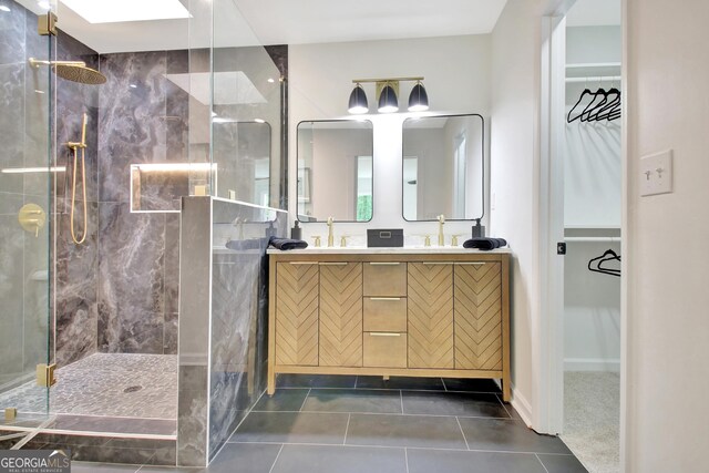 full bathroom featuring double vanity, tile patterned floors, and a tile shower