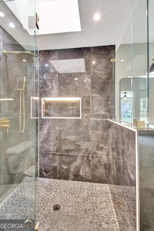 bathroom with a stall shower and recessed lighting