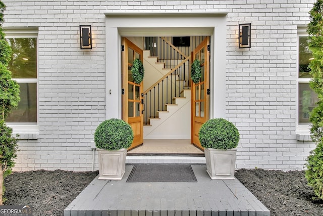 doorway to property featuring brick siding