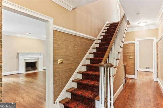 769 Hampton Pl SW, Marietta, GA 30064 - stairs with crown molding, visible vents, wood finished floors, baseboards, and a fireplace with flush hearth