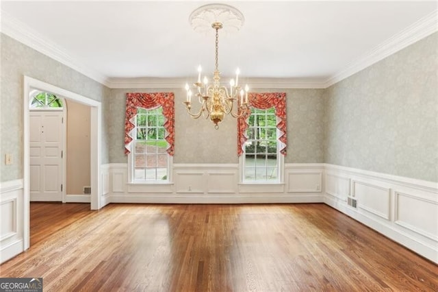 769 Hampton Pl SW, Marietta, GA 30064 - unfurnished dining area featuring visible vents, crown molding, wainscoting, wood finished floors, and a chandelier