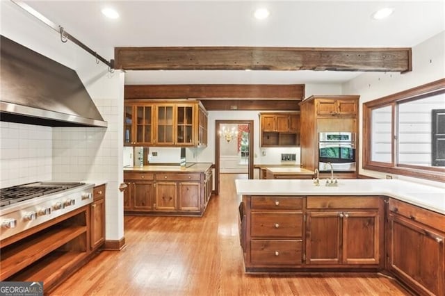 769 Hampton Pl SW, Marietta, GA 30064 - kitchen featuring range hood, light wood-style flooring, stainless steel oven, and beam ceiling