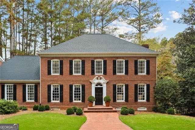 769 Hampton Pl SW, Marietta, GA 30064 - colonial-style house featuring brick siding, a shingled roof, and a front lawn