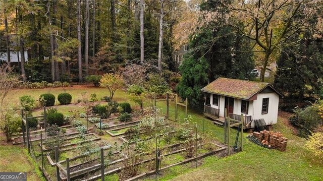 769 Hampton Pl SW, Marietta, GA 30064 - view of yard featuring an outbuilding, fence, and a vegetable garden