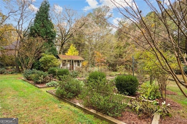769 Hampton Pl SW, Marietta, GA 30064 - view of yard featuring an outdoor structure and a garden