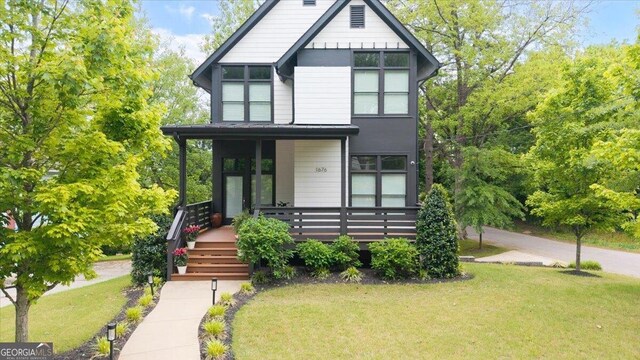 1676 Carroll Dr NW, Atlanta, GA 30318 - view of front facade featuring covered porch and a front yard