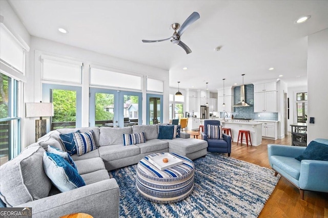 1676 Carroll Dr NW, Atlanta, GA 30318 - living room featuring ceiling fan, french doors, recessed lighting, and light wood-style flooring