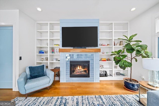 1676 Carroll Dr NW, Atlanta, GA 30318 - living area featuring recessed lighting, built in features, wood finished floors, and a fireplace