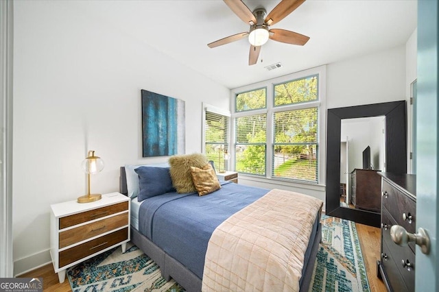 1676 Carroll Dr NW, Atlanta, GA 30318 - bedroom with baseboards, a ceiling fan, wood finished floors, and visible vents