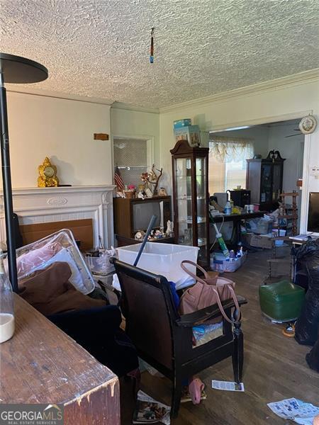 2689 Knox St, Atlanta, GA 30317 - living area with ornamental molding, a textured ceiling, and wood finished floors