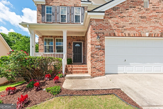 3845 New Salem Ct, Cumming, GA 30040 - view of front facade with brick siding, driveway, a garage, and covered porch