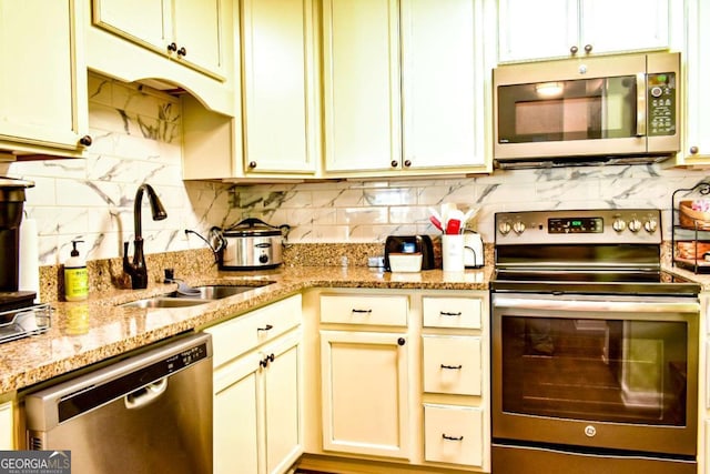 5301 Walden Park Dr Unit 5301, Savannah, GA 31410 - kitchen with appliances with stainless steel finishes, tasteful backsplash, and light stone counters