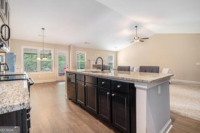 kitchen with a sink, dishwasher, dark cabinetry, vaulted ceiling, and dark wood-style floors